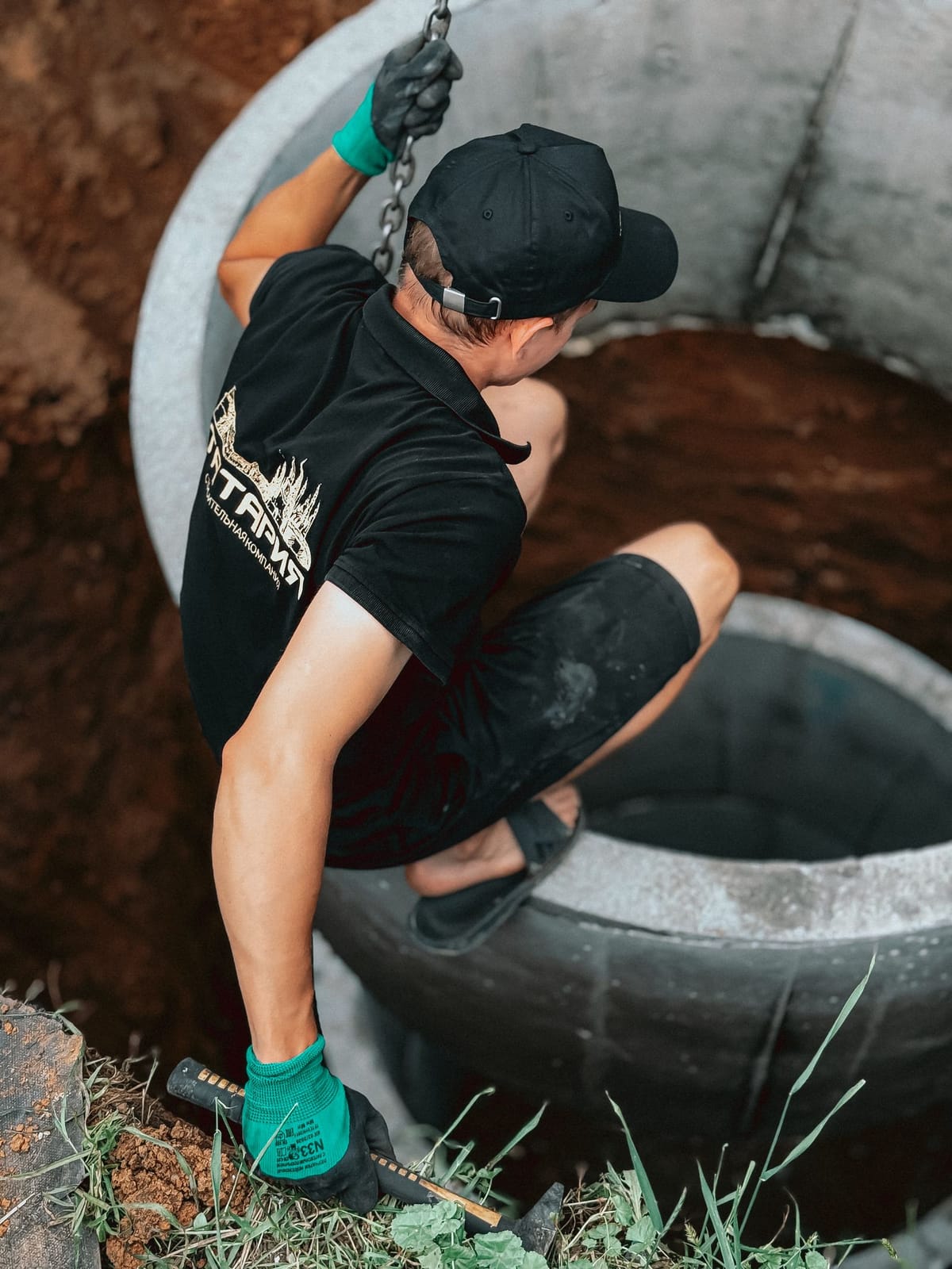 Open excavation with a new concrete septic tank being set at a Capital Region home